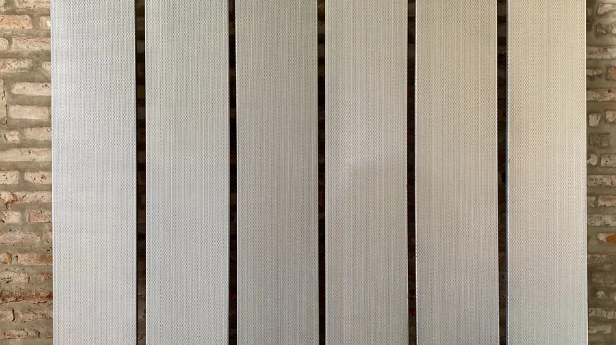 Chapas perforadas apoyadas contra la pared del taller